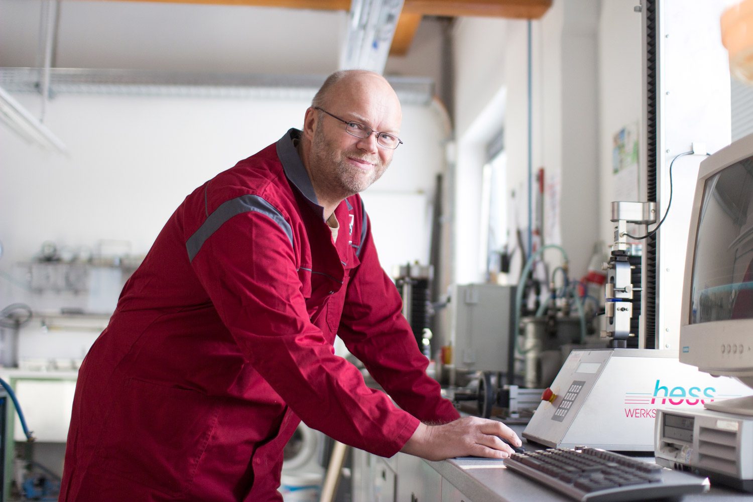 Employee stands in front of the desk