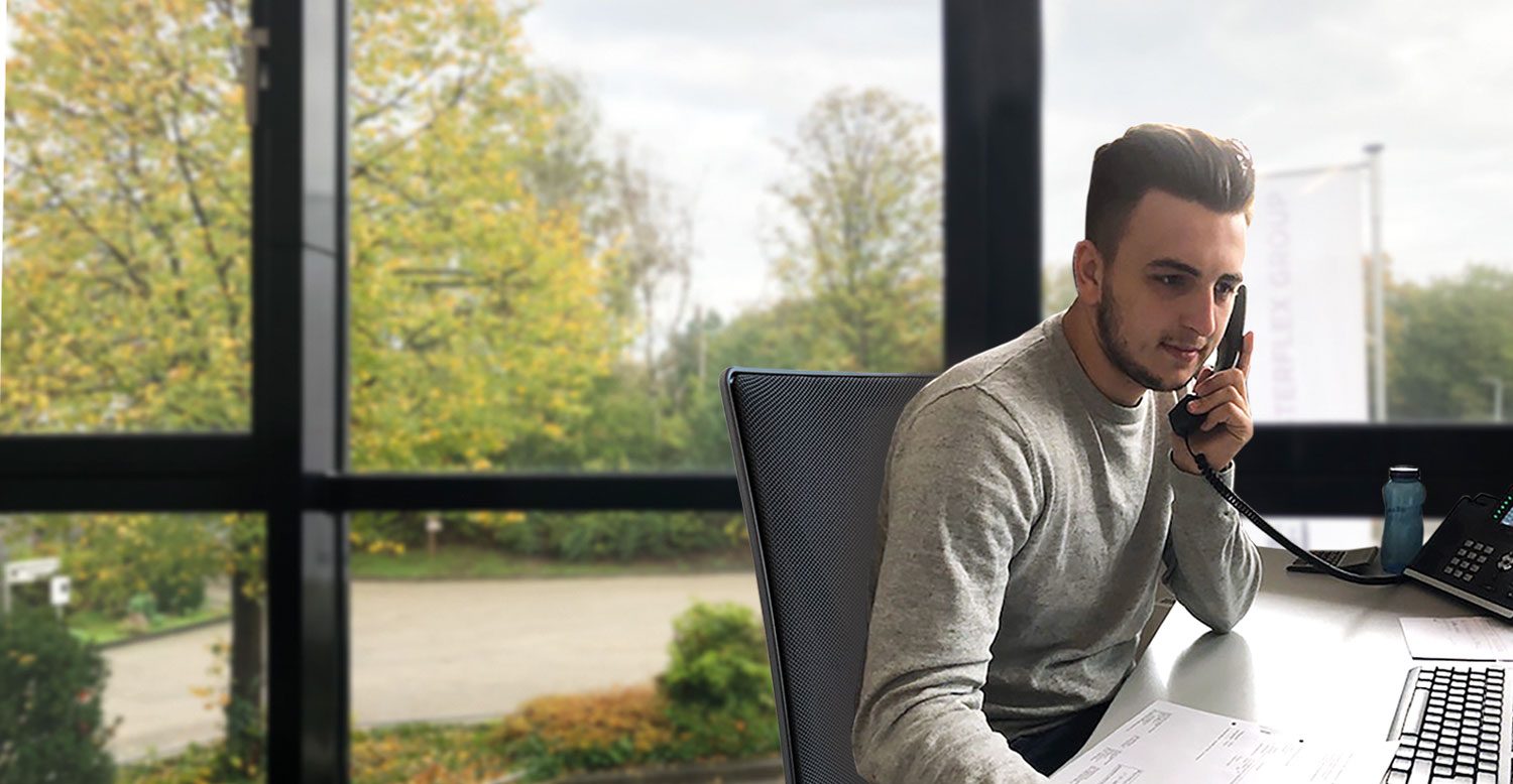 Man sitting at desk and talking on phone