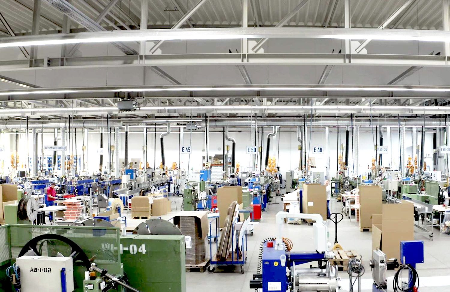 Another view into the Novoplast production hall with various machines and materials stored in a box..