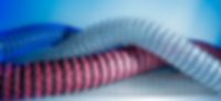 Masterflex Group Our Products Masterflex Spiral Hoses Four different hoses in different colours e.g. black/blue or red/black to show the diversity.