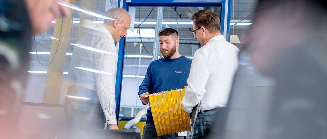Mood picture: Masterduct employees talking in the warehouse
