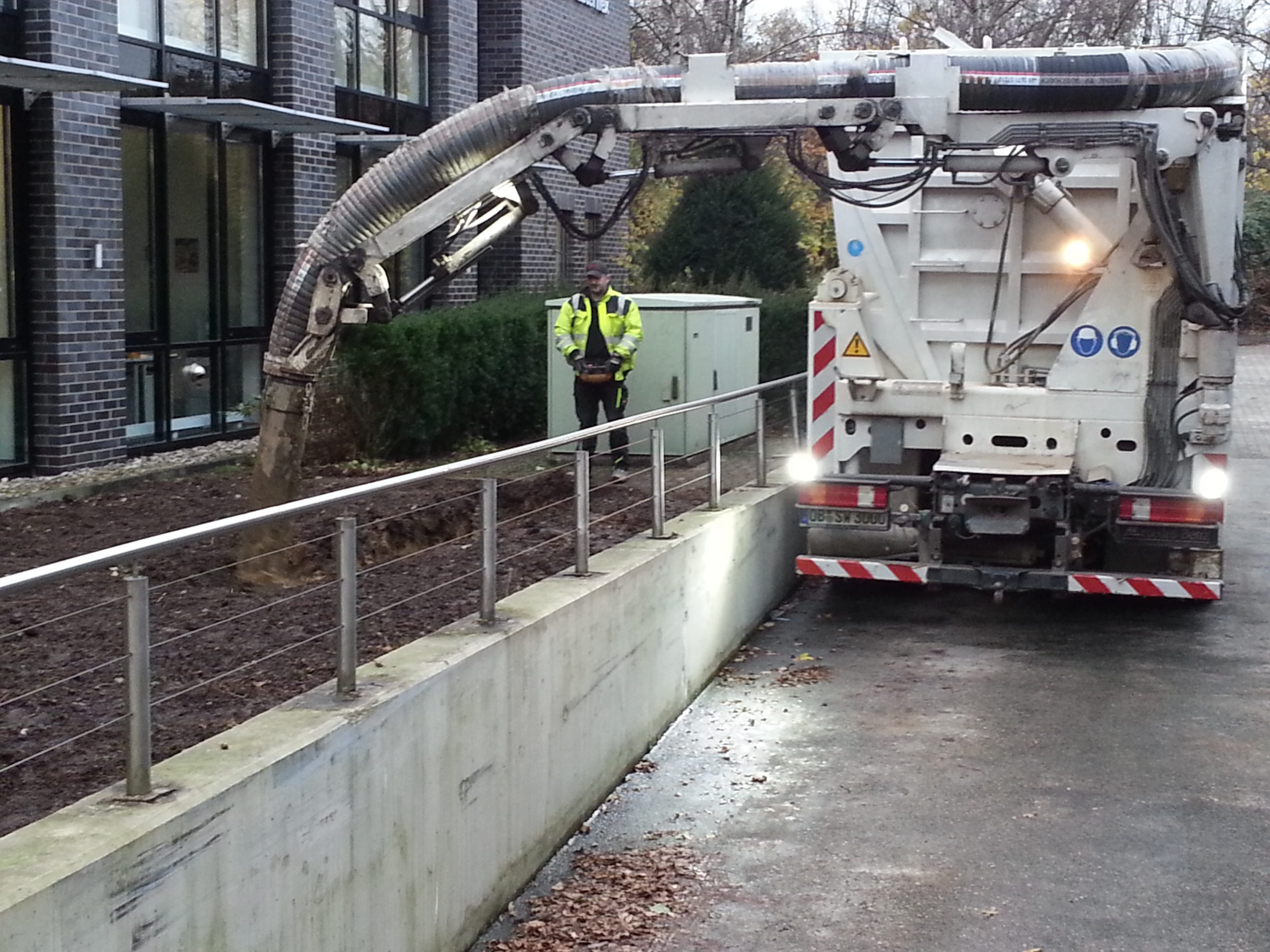 Extraction and conveyance of abrasive materials on construction sites, in gravel and sand pits, and in municipal cleaning operations