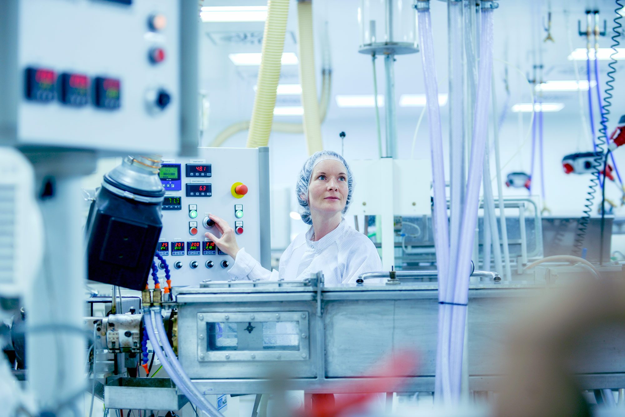 An employee works on a machine in the clean room.