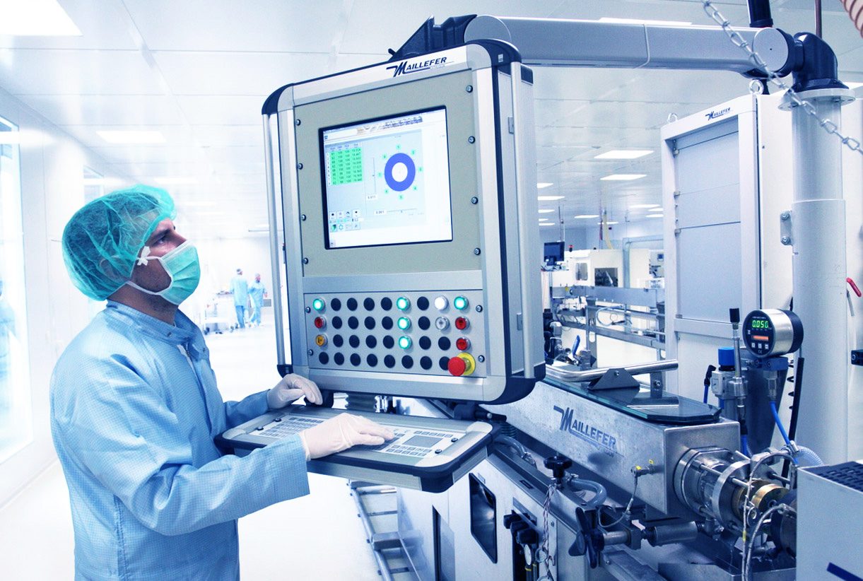 An employee checks production on the display of a machine in the clean room. 